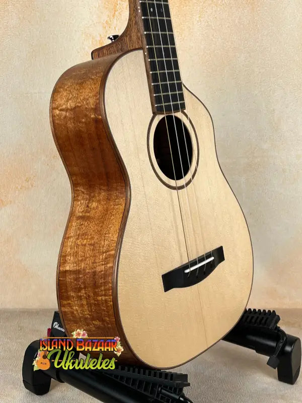 Wooden ukulele on stand from Mya-Moe Long Neck Tenor Ukulele spruce top koa back