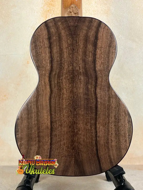 Acoustic guitar with dark wood grain showcasing Nebula Tenor Ukulele craftsmanship