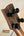 Guitar headstock with black tuning pegs on brown wood, showcasing Nebula Tenor Ukulele design