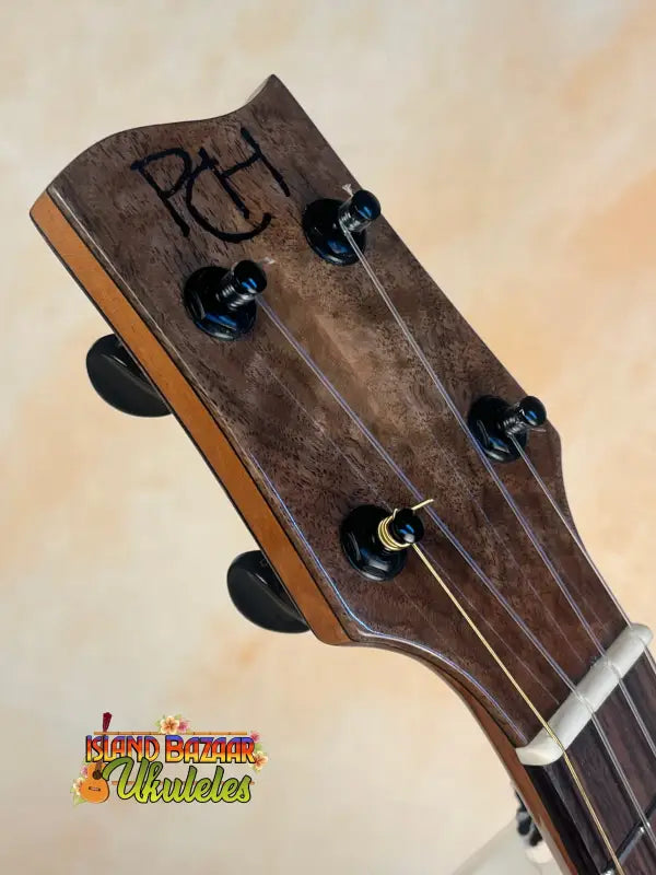 Wooden ukulele headstock with black tuning pegs and PH branding for Nebula Tenor Ukulele