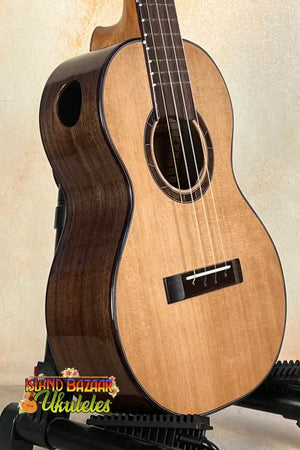 Wooden Nebula Tenor Ukulele in Western Red Cedar and Claro Walnut on a stand