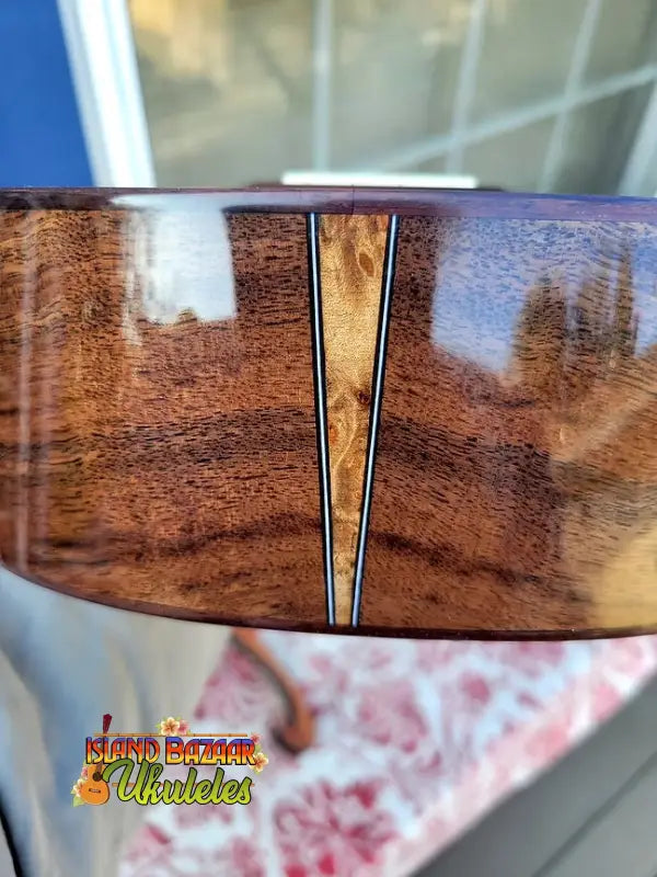 Wooden surface with decorative seam on Nebula Tenor Ukulele in Western Red Cedar and Claro Walnut craftsmanship