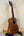 Wooden Kamaka Concert Ukulele HF-2 in solid koa on a black stand with hard case