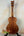 Wooden Kamaka Concert Ukulele HF-2 in solid koa resting on a black stand