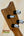 Guitar headstock of Kamaka HF-2 Ukulele with black and white tuners on solid koa wood