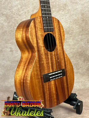 Wooden Kamaka HF-3 tenor ukulele on stand, solid koa, perfect for enthusiasts