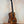 Beautiful Premium Curly Koa Kanile’a Honus Tenor Ukulele on a black stand