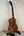 Beautiful Premium Curly Koa Kanile’a Honus Tenor Ukulele on a black stand