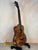 Beautiful Premium Curly Koa Kanile’a Honus Tenor Ukulele on a black stand