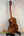Wooden acoustic guitar showcasing rich brown Koa grain in Kanile’a Honus Tenor Ukulele