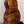 Acoustic guitar back of Kanile’a Honus Tenor Ukulele in premium curly koa wood