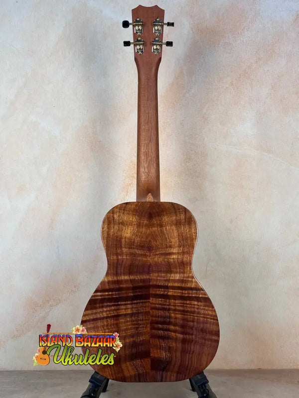 Acoustic guitar with rich brown koa wood grain patterning in Kanile’a Honus Tenor Ukulele