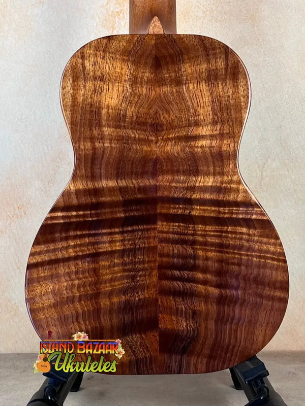 Acoustic guitar featuring Premium Curly Koa back in Kanile’a Honus Tenor Ukulele