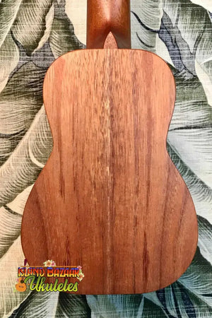 Wooden acoustic guitar back panel showcasing natural wood grain of Kanile’a K-1 Soprano