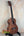 Wooden Kamaka HF-3I Slothead Tenor Ukulele on a black stand for display