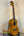 Ohana CK-150SMP Spalted Mango Concert Ukulele with Abalone Rosette on a stand