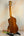 Wooden ukulele on a stand showcasing Ohana CK-370G Concert in Solid Hawaiian Koa