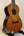 Ohana CK-50G Solid Cedar & Rosewood Concert Ukulele on black stand with four strings