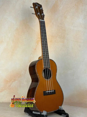 Ohana CK-50G Solid Cedar & Rosewood Concert Ukulele with natural finish and four strings
