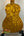 Golden acoustic guitar with rippled wood grain, showcasing Ohana CK-50WG Concert Ukulele