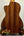 Acoustic guitar with wooden back on stand, showcasing Ohana CK-60CG Mahogany Concert Ukulele