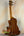 Ohana CK-60CG Mahogany Concert Ukulele elegantly displayed on a stand