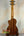 Ohana CK-60CG Mahogany Concert Ukulele with cutaway, dark brown body on stand