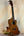 Wooden ukulele with natural finish on stand, Ohana CK-60CG Mahogany Concert Ukulele