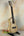 Light-colored wooden Ohana CK-75CG Concert Ukulele on a black stand, limited edition