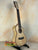 Light-colored wooden Ohana CK-75CG Concert Ukulele on a black stand, limited edition