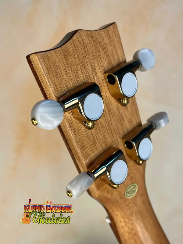 Guitar headstock with tuning pegs showcasing Ohana CK-75CG Concert Ukulele’s spruce finish