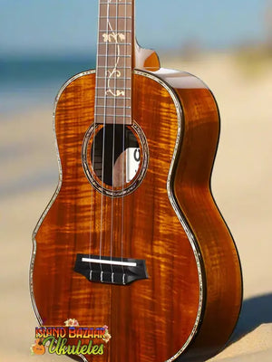 Ornate brown ukulele from Ohana Limited Edition 575G Series Koa Tenor Ukulele Bundle