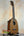 Pineapple-shaped ukulele on stand, showcasing Ohana PKC-50G Solid Cedar & Mahogany design