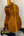 Wooden acoustic guitar with rich brown finish on stand, Ohana TK-350G Tenor Ukulele