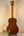 Wooden acoustic guitar with natural finish on display, Ohana TK-35G Solid Mahogany Tenor