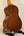 Ohana TK-35G Solid Mahogany Tenor Ukulele resting on a black stand for display