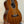 Ohana TK-35G Solid Mahogany Tenor Ukulele showcasing dark wood grain and four strings