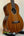 Ohana TK-35G Solid Mahogany Tenor Ukulele showcasing dark wood grain and four strings