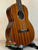 Ohana TK-35G Solid Mahogany Tenor Ukulele showcasing dark wood grain and four strings