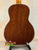 Wooden back panel of Ohana TK-35G Solid Mahogany Tenor Ukulele on display stand