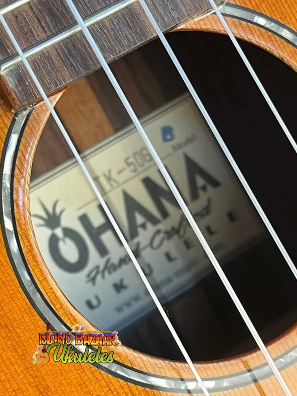 Ohana TK-50G solid cedar tenor ukulele showcasing strings and sound hole details