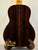 Dark rosewood back panel of Ohana TK-50G Solid Cedar Tenor Ukulele on wooden stand