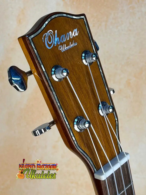 Ohana TK-50G headstock featuring chrome tuning pegs on a solid cedar tenor ukulele