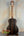 Acoustic guitar with dark striped wood grain back of Ohana TK-50ME Solid Cedar Tenor Ukulele