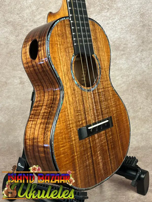 Flamed koa wood acoustic-electric ukulele with abalone purfling and soundhole rosette