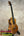 Glossy solid Hawaiian Koa PCH Sunshine Tenor Ukulele with ebony fretboard on stand