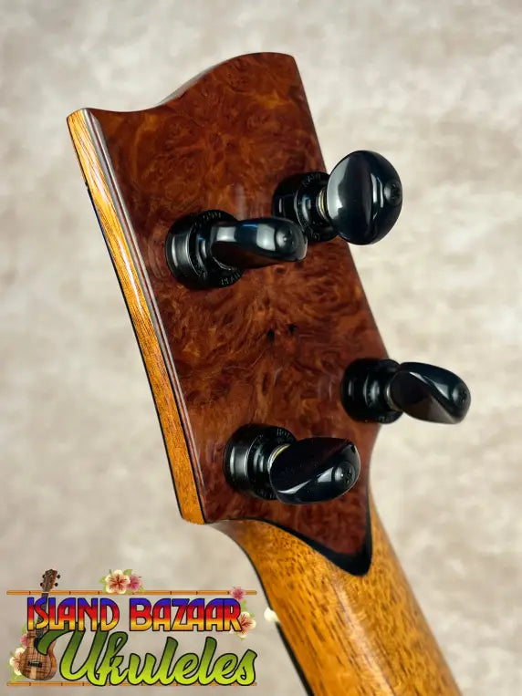Burled wood ukulele headstock with black tuning pegs on PCH Sunshine Tenor Ukulele featuring solid Hawaiian Koa