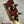 PCH Wickered Oregon Myrtle ukulele headstock with dark reddish-brown wood and gold tuning pegs