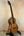 Brown wooden tenor ukulele on stand from PCH Sunshine Phil Henderson with solid Hawaiian koa
