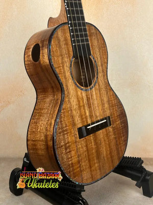 Brown wooden tenor ukulele made of solid Hawaiian Koa by Phil Henderson